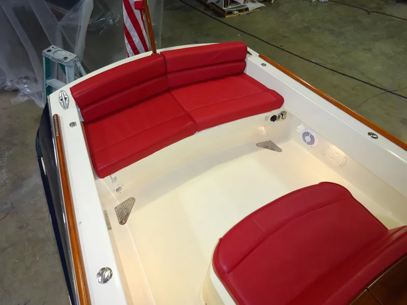 Slide: The Image of 2007 Hinckley T29C boat interior with red seating and American flag. - 32