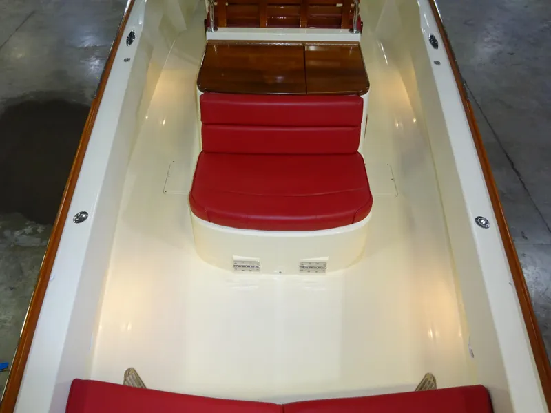 Slide: The Image of 2007 Hinckley T29C boat interior with red seating and wooden table. - 33