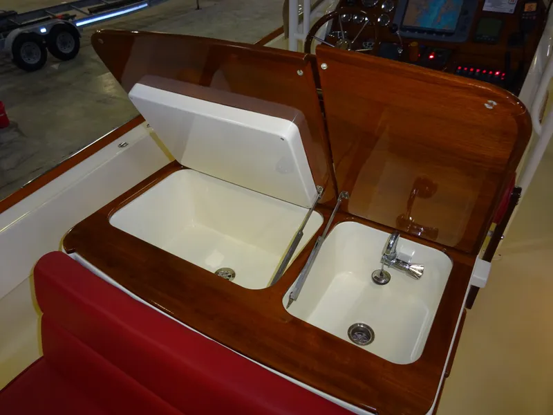 Slide: The Image of 2007 Hinckley T29C boat interior with wooden sink and storage compartments. - 34