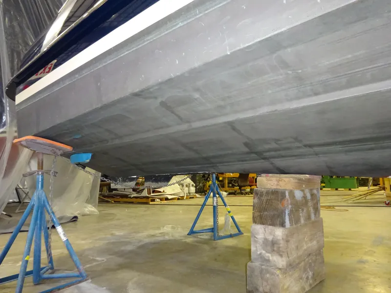 Slide: The Image of Hinckley T29C 2007 boat hull supported by stands in a workshop. - 44