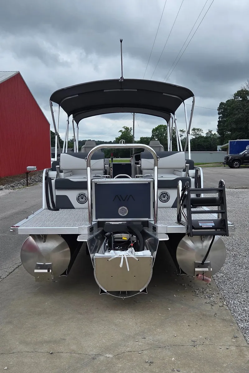 Slide: The Image of 2025 Avalon Platinum LSZ 2585 Quad Lounger Shift pontoon boat, rear view, parked outdoors. - 2