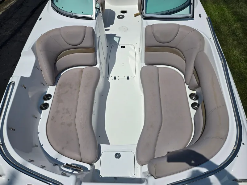Slide: The Image of 2014 Hurricane SunDeck 2200 OB boat interior with spacious seating and cup holders. - 10