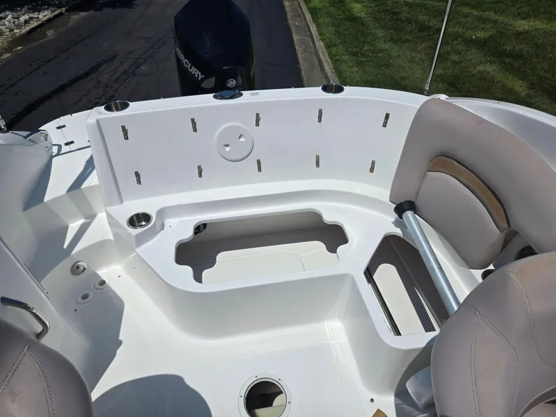 Slide: The Image of 2014 Hurricane SunDeck 2200 OB boat interior with seating and storage compartments. - 13