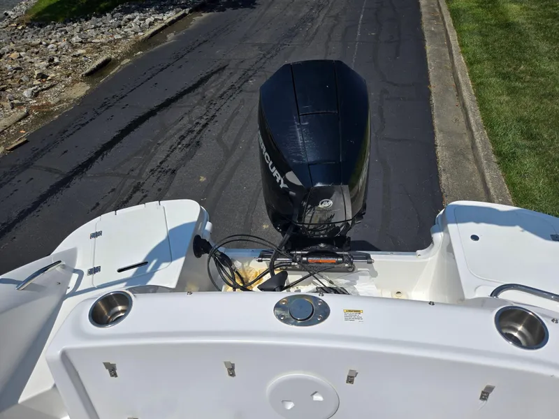 Slide: The Image of 2014 Hurricane SunDeck 2200 OB boat with outboard motor on a trailer. - 14