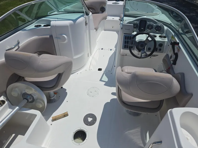 Slide: The Image of 2014 Hurricane SunDeck 2200 OB boat interior with steering wheel and seating. - 15