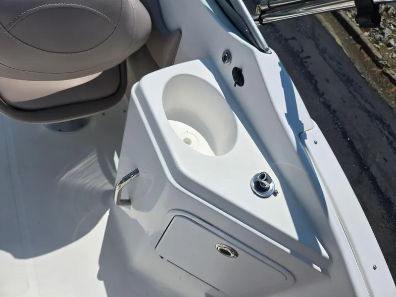 Slide: The Image of 2014 Hurricane SunDeck 2200 OB boat console with cup holder and storage compartment. - 16