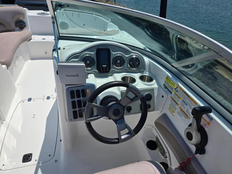 Slide: The Image of 2014 Hurricane SunDeck 2200 OB boat dashboard with steering wheel and Garmin device. - 17