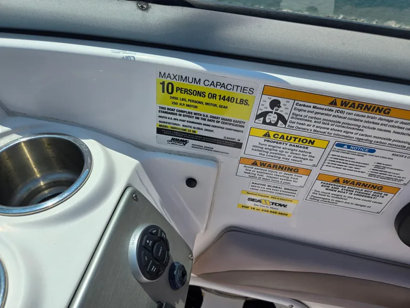 Slide: The Image of 2014 Hurricane SunDeck 2200 OB boat capacity and safety warning labels. - 18