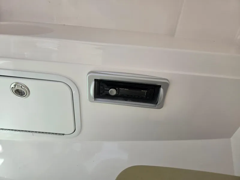 Slide: The Image of 2014 Hurricane SunDeck 2200 OB boat dashboard with control panel and storage compartment. - 20