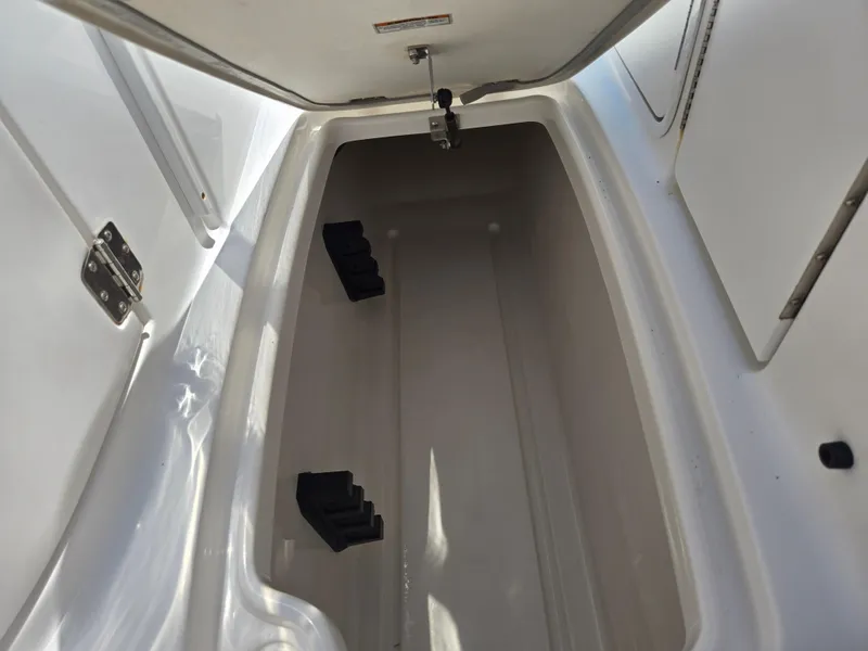 Slide: The Image of Open storage compartment in 2014 Hurricane SunDeck 2200 OB boat. - 21