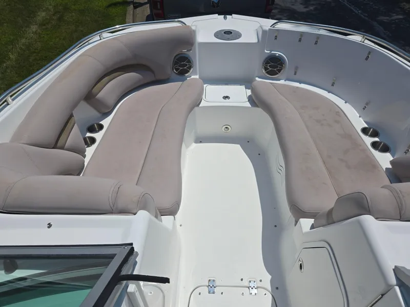 Slide: The Image of 2014 Hurricane SunDeck 2200 OB boat interior with spacious seating and cup holders. - 22