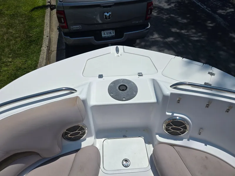 Slide: The Image of 2014 Hurricane SunDeck 2200 OB boat interior with seating and storage compartments. - 23