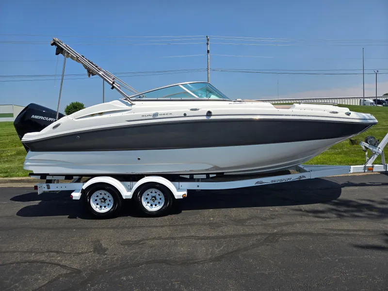 Slide: The Image of 2014 Hurricane SunDeck 2200 OB boat on trailer, parked outdoors under clear sky. - 4
