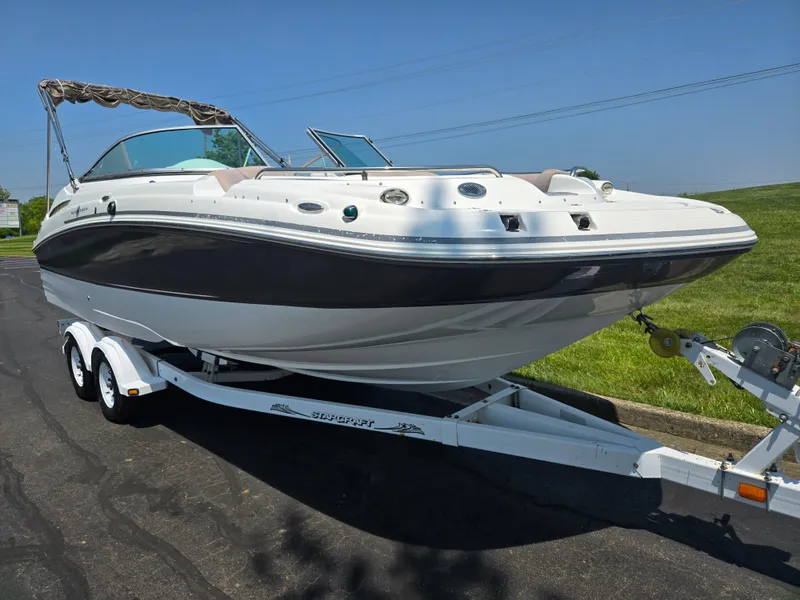 Slide: The Image of 2014 Hurricane SunDeck 2200 OB boat on trailer, parked on asphalt near grass. - 5