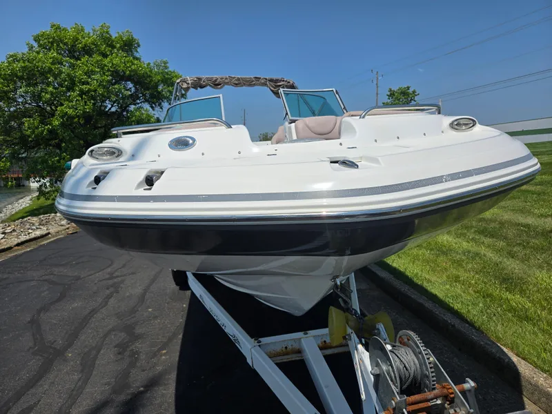 Slide: The Image of 2014 Hurricane SunDeck 2200 OB boat on trailer, parked on asphalt near grass. - 6
