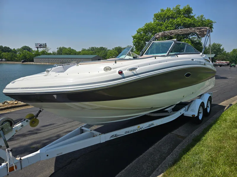 Slide: The Image of 2014 Hurricane SunDeck 2200 OB boat on trailer by waterfront, sunny day. - 8
