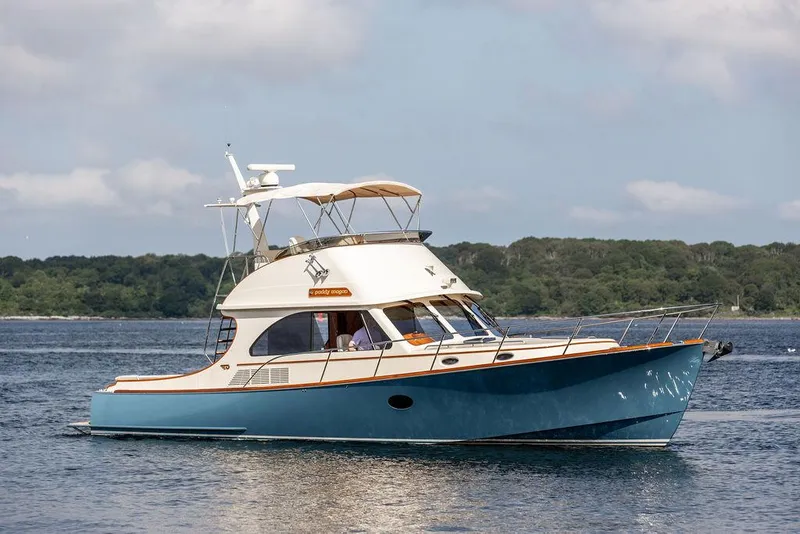 Slide: The Image of 2017 Hinckley Talaria 43 Flybridge yacht cruising on calm waters. - 0