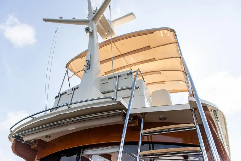 Slide: The Image of 2017 Hinckley Talaria 43 Flybridge yacht with ladder and canopy, viewed from below. - 10