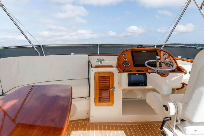 Slide: The Image of Flybridge of 2017 Hinckley Talaria 43, featuring elegant seating and advanced navigation controls. - 12