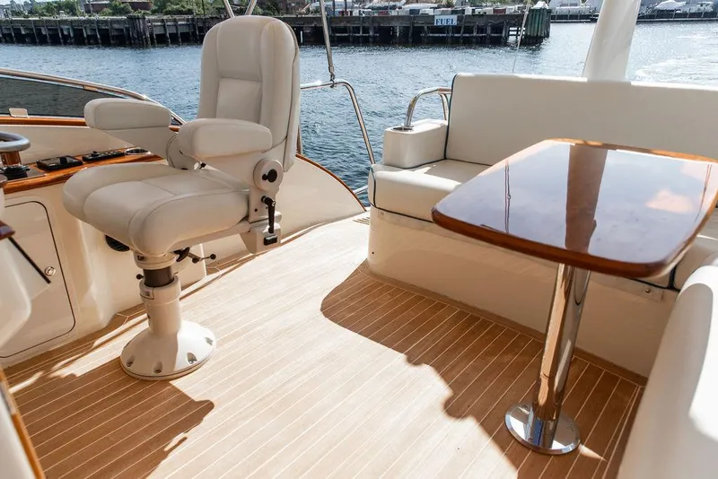 Slide: The Image of Luxurious 2017 Hinckley Talaria 43 Flybridge interior with elegant seating and polished wood table. - 13