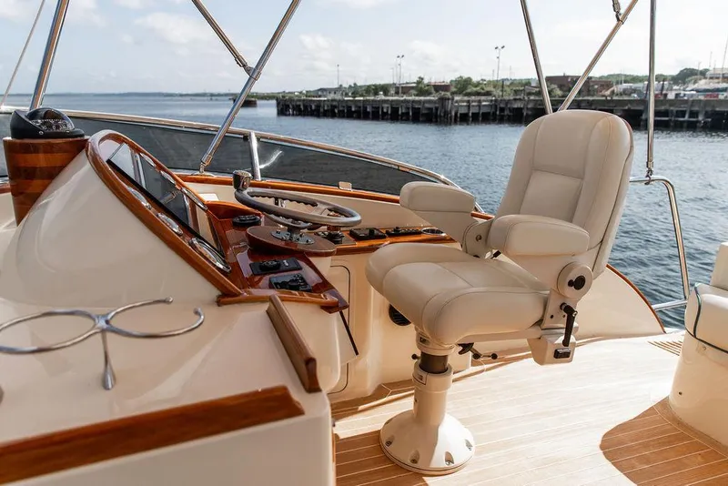 Slide: The Image of Luxurious helm of 2017 Hinckley Talaria 43 Flybridge yacht with leather captain's chair. - 14
