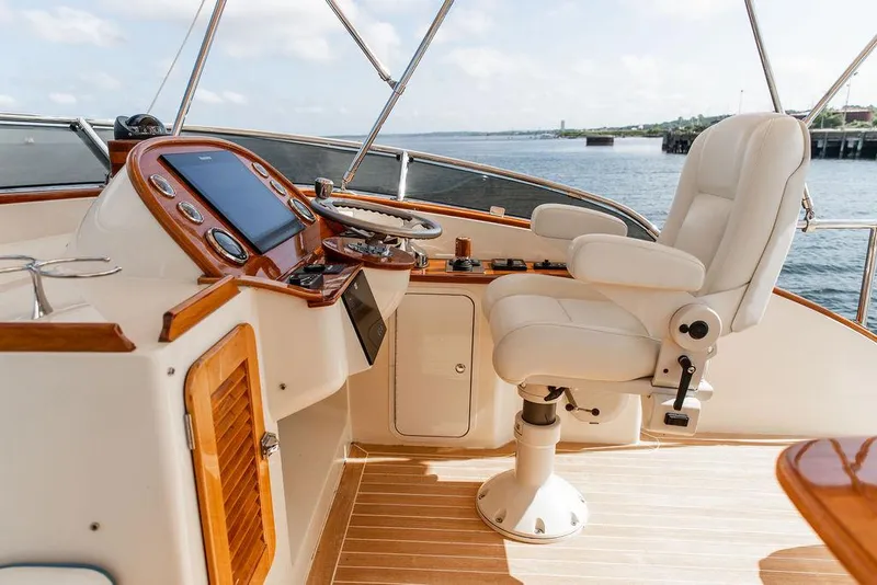 Slide: The Image of Helm of 2017 Hinckley Talaria 43 Flybridge with luxurious seating and controls. - 16