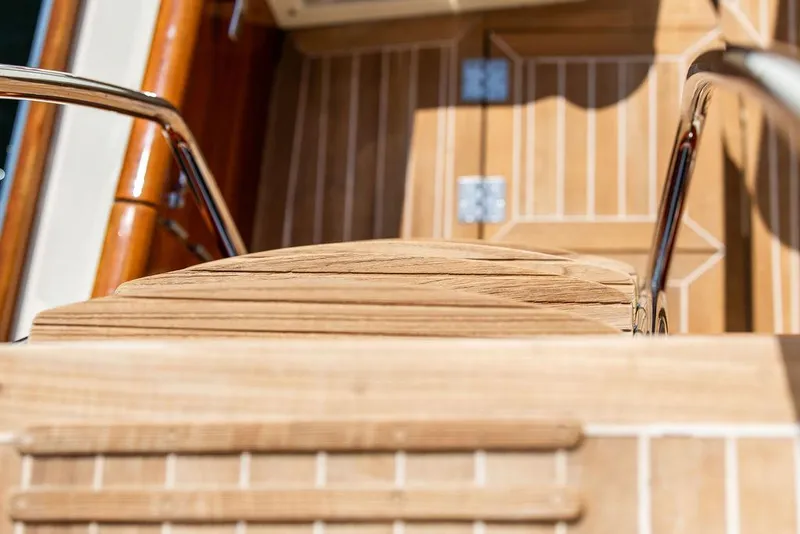 Slide: The Image of Teak steps and railing on 2017 Hinckley Talaria 43 Flybridge yacht. - 18
