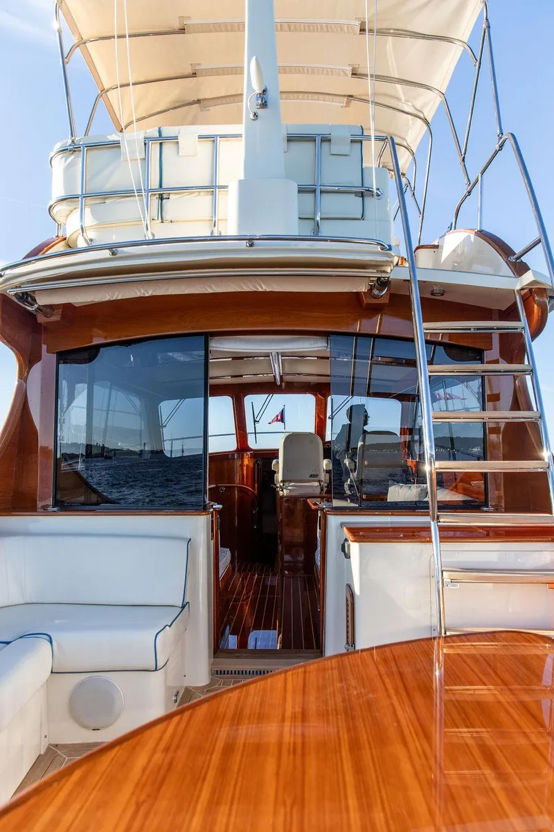 Slide: The Image of 2017 Hinckley Talaria 43 Flybridge yacht with elegant wood finish and spacious seating. - 19