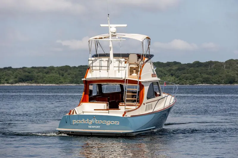 Slide: The Image of 2017 Hinckley Talaria 43 Flybridge yacht cruising on calm waters. - 2