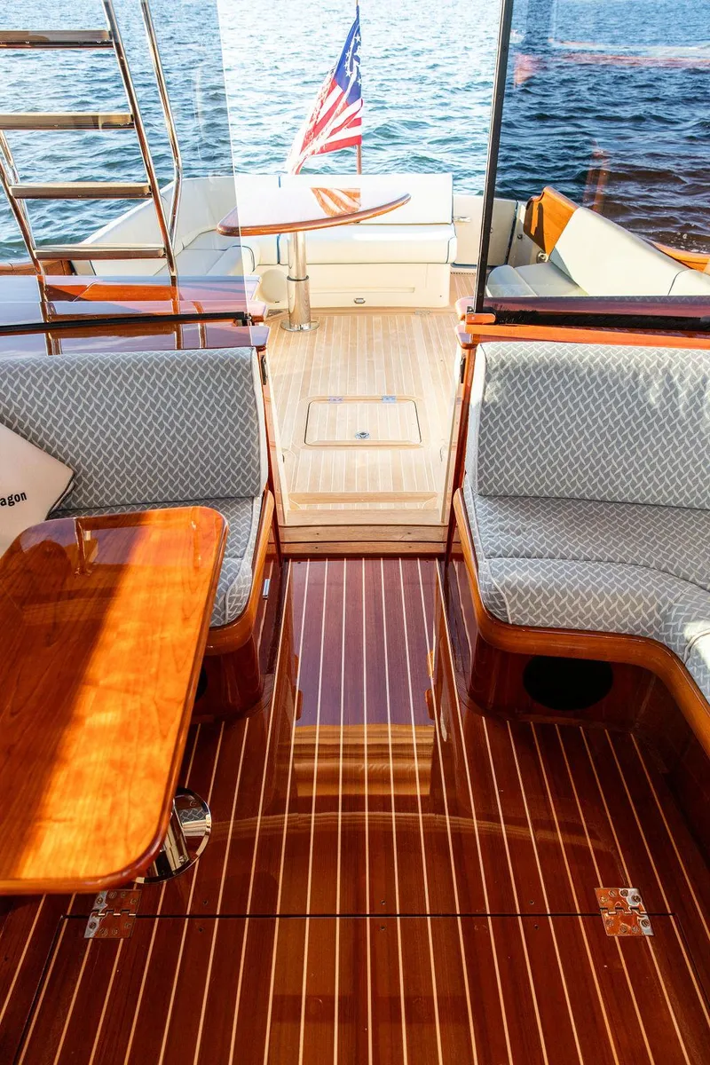 Slide: The Image of Luxurious 2017 Hinckley Talaria 43 Flybridge interior with polished wood and elegant seating. - 20