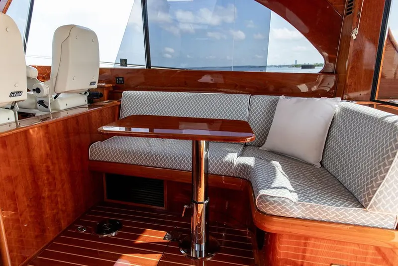 Slide: The Image of Luxurious interior of 2017 Hinckley Talaria 43 Flybridge with elegant seating and wooden finishes. - 21