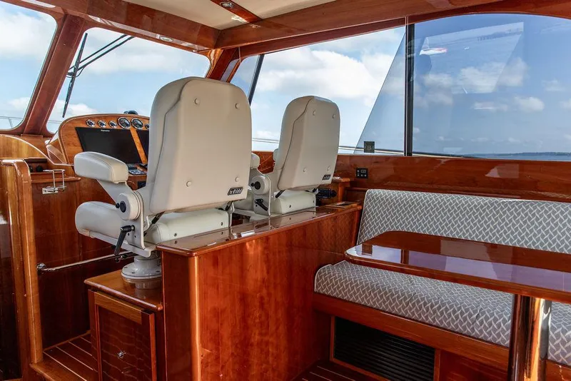 Slide: The Image of Interior of 2017 Hinckley Talaria 43 Flybridge with helm seats and seating area. - 22