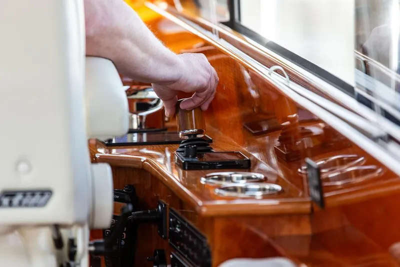 Slide: The Image of Hand operating controls on 2017 Hinckley Talaria 43 Flybridge yacht dashboard. - 24