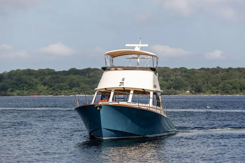 Slide: The Image of 2017 Hinckley Talaria 43 Flybridge yacht cruising on calm waters. - 3