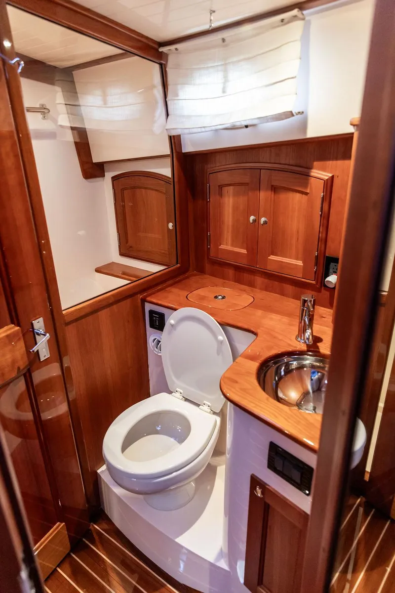 Slide: The Image of Luxurious 2017 Hinckley Talaria 43 Flybridge yacht bathroom with wood accents and modern fixtures. - 31