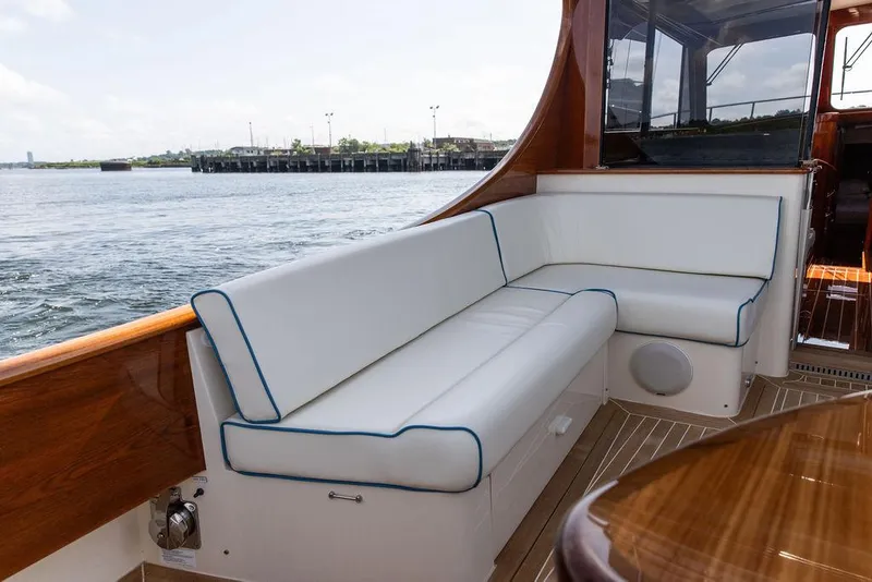 Slide: The Image of Luxurious seating on 2017 Hinckley Talaria 43 Flybridge yacht, overlooking serene waterfront. - 6