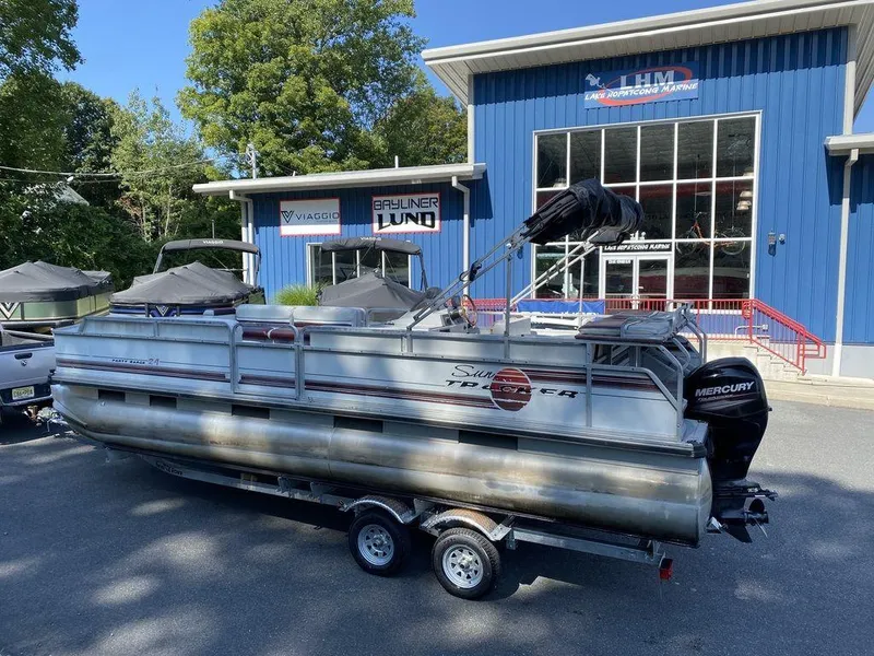 Slide: The Image of 1994 Sun Tracker Party Barge 24 pontoon boat on trailer outside dealership. - 2