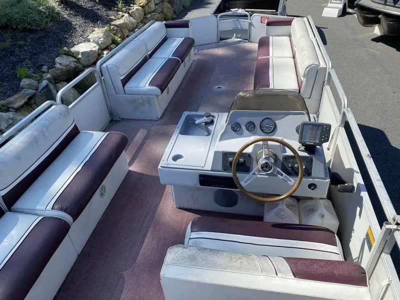 Slide: The Image of 1994 Sun Tracker Party Barge 24 pontoon boat interior with seating and steering console. - 3