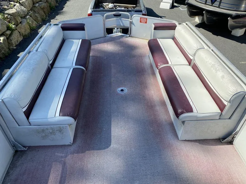 Slide: The Image of 1994 Sun Tracker Party Barge 24 interior with maroon and white seating. - 6