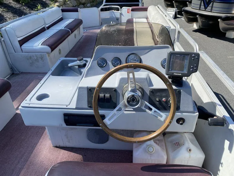 Slide: The Image of 1994 Sun Tracker Party Barge 24 boat interior with steering wheel and control panel. - 7