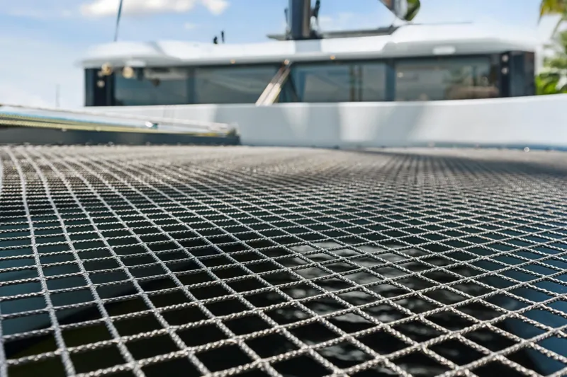 Slide: The Image of Trampoline netting on 2019 McConaghy MC60 catamaran, with blurred cabin in background. - 15