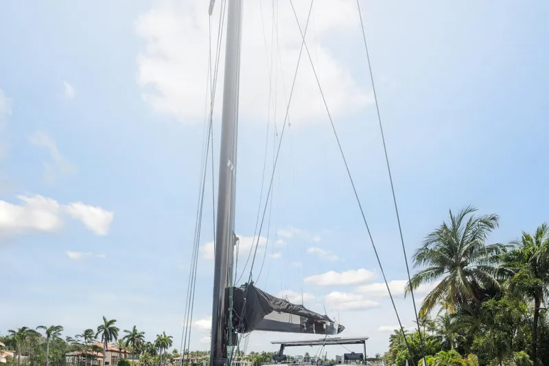 Slide: The Image of 2019 McConaghy MC60 yacht mast against a clear blue sky with palm trees. - 17
