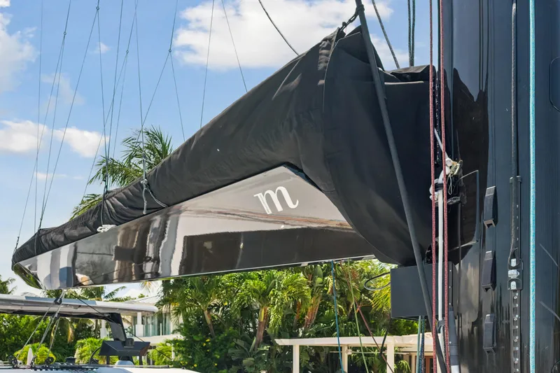 Slide: The Image of 2019 McConaghy MC60 yacht mast with black sail cover, tropical background. - 21