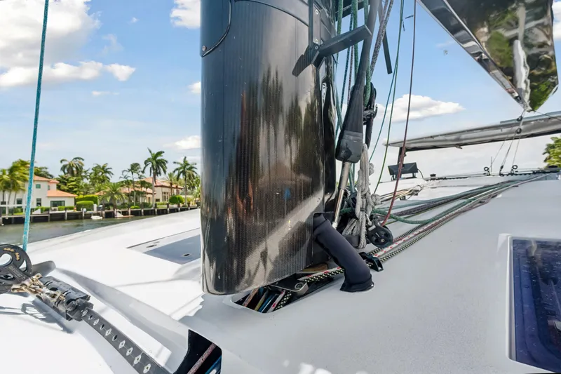 Slide: The Image of 2019 McConaghy MC60 yacht deck with mast and rigging, palm trees in background. - 22