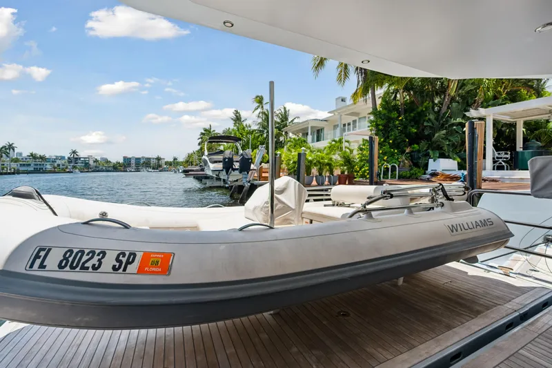 Slide: The Image of 2019 McConaghy MC60 yacht with Williams tender docked by waterfront homes. - 23