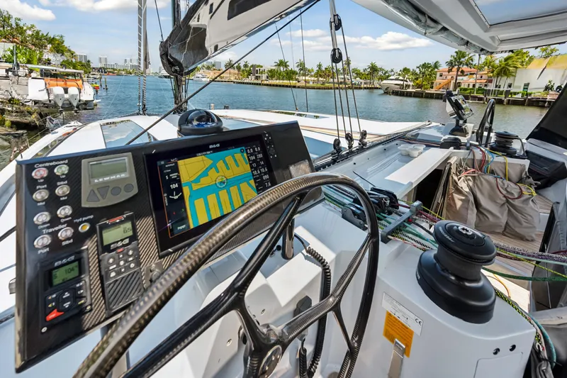 Slide: The Image of Cockpit view of 2019 McConaghy MC60 yacht with navigation equipment and scenic waterfront. - 35