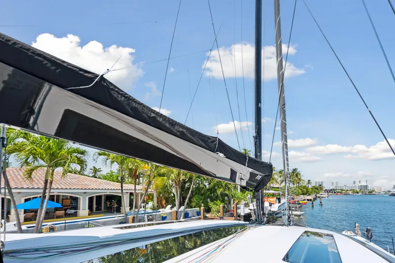 Slide: The Image of 2019 McConaghy MC60 yacht docked by waterfront homes under a clear blue sky. - 38