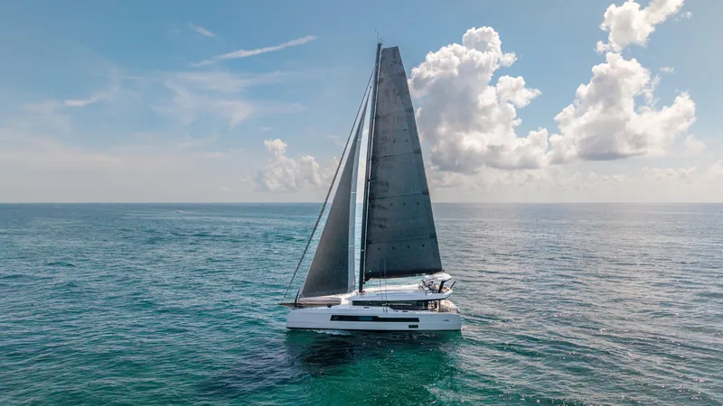 Slide: The Image of 2019 McConaghy MC60 sailing on open ocean under a clear blue sky. - 6