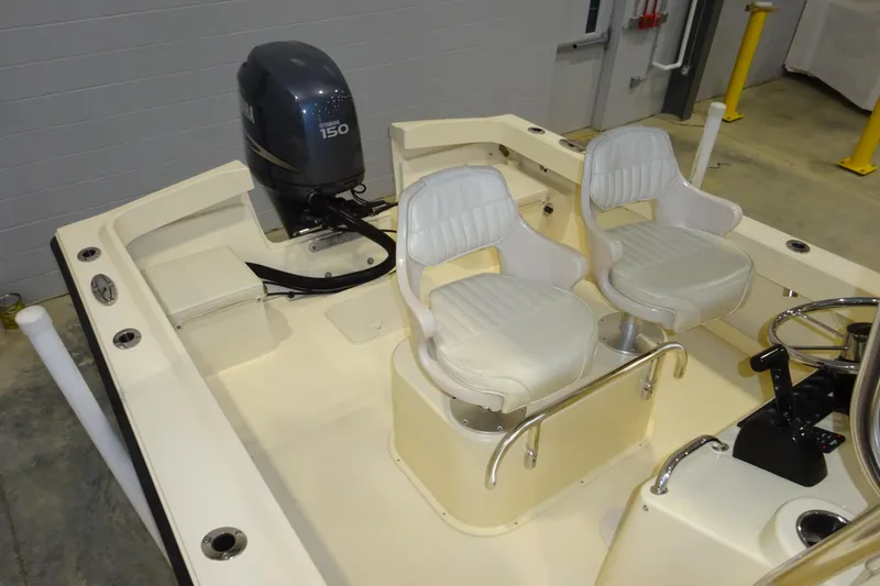 Slide: The Image of 2012 Parker 21 Special Edition boat interior with dual white seats and outboard motor. - 21