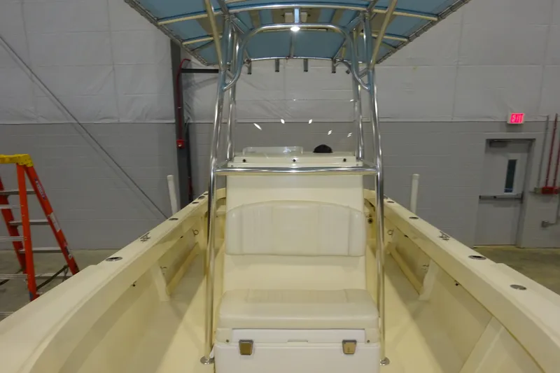 Slide: The Image of 2012 Parker 21 Special Edition boat interior with seating and T-top in a warehouse setting. - 28